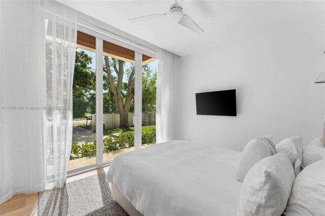 335 W 46th St, Miami Beach, FL 33140 - bedroom featuring wood-type flooring, ceiling fan, and access to outside