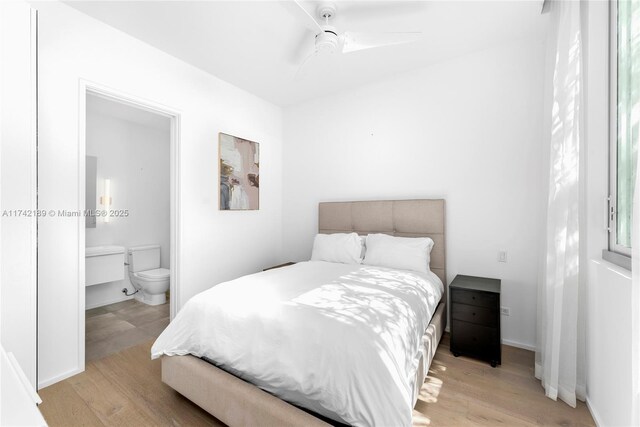 335 W 46th St, Miami Beach, FL 33140 - bedroom with ceiling fan, light hardwood / wood-style flooring, and ensuite bath