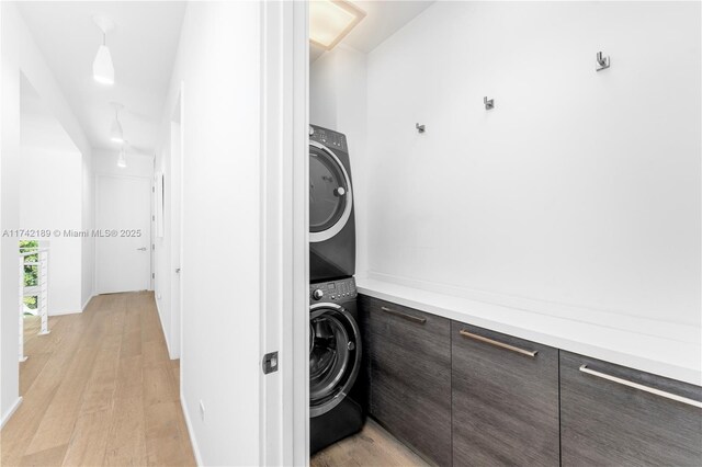 335 W 46th St, Miami Beach, FL 33140 - laundry room featuring light wood-type flooring and stacked washer and dryer