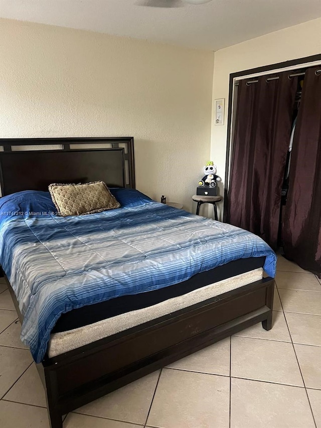 tiled bedroom featuring a closet