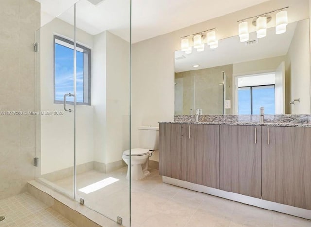 full bath with a shower stall, double vanity, tile patterned floors, and toilet