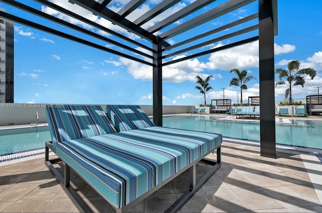 view of patio with a community pool and a pergola