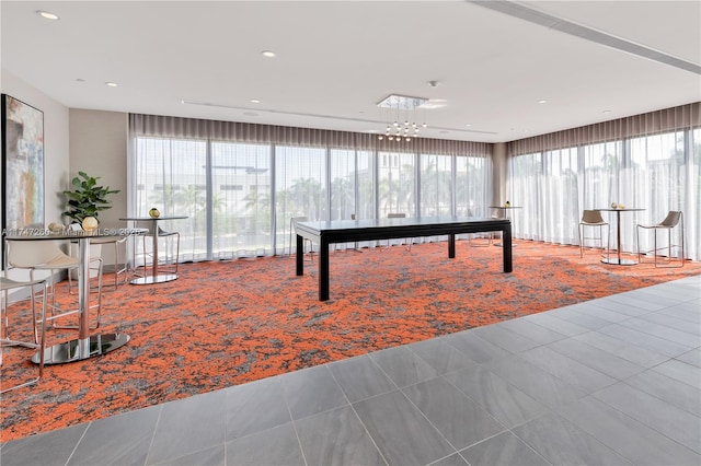 game room featuring tile patterned flooring, a chandelier, and recessed lighting