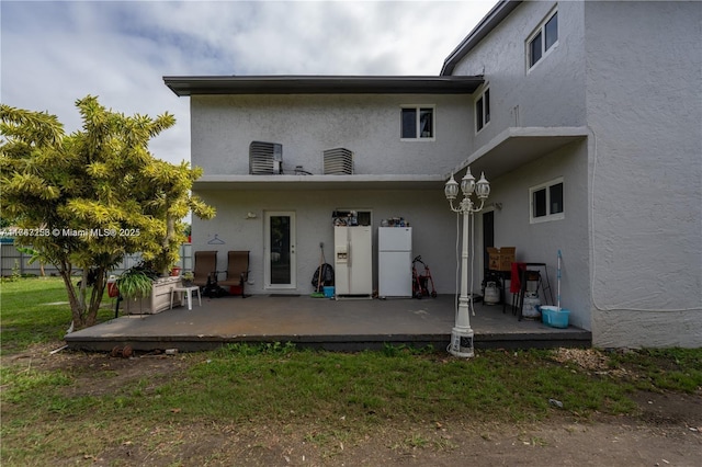 back of house with central AC and a patio