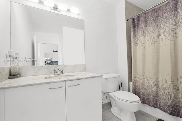 bathroom featuring toilet, vanity, and curtained shower