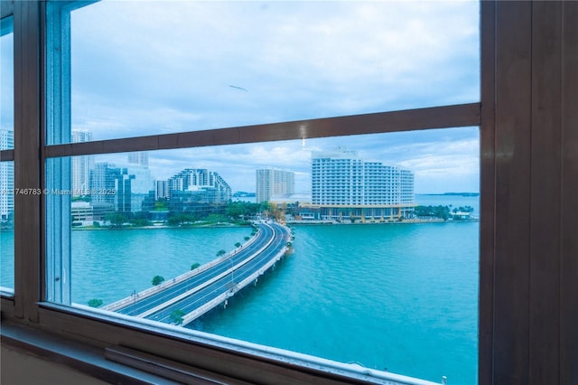 view of pool featuring a water view and a view of city