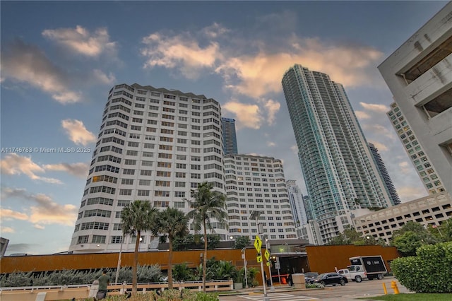 property at dusk featuring a city view