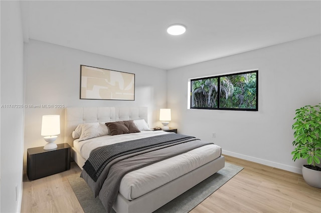 bedroom featuring light wood-type flooring and baseboards