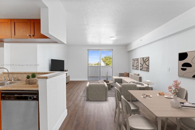 dining room featuring a textured ceiling, baseboards, and wood finished floors