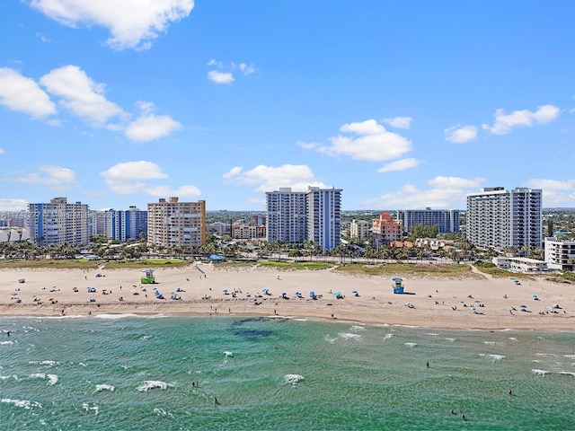 birds eye view of property with a water view and a view of the beach