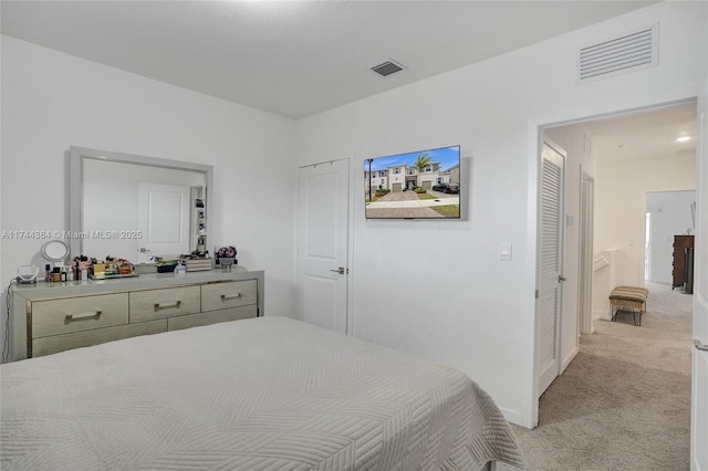 bedroom with light carpet, visible vents, and baseboards