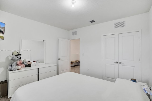 bedroom with a closet, carpet, and visible vents