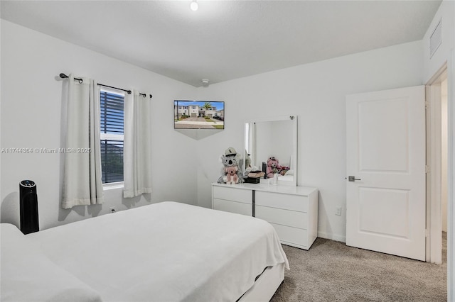 bedroom featuring visible vents and light colored carpet