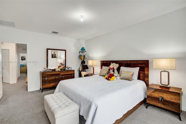 carpeted bedroom featuring visible vents