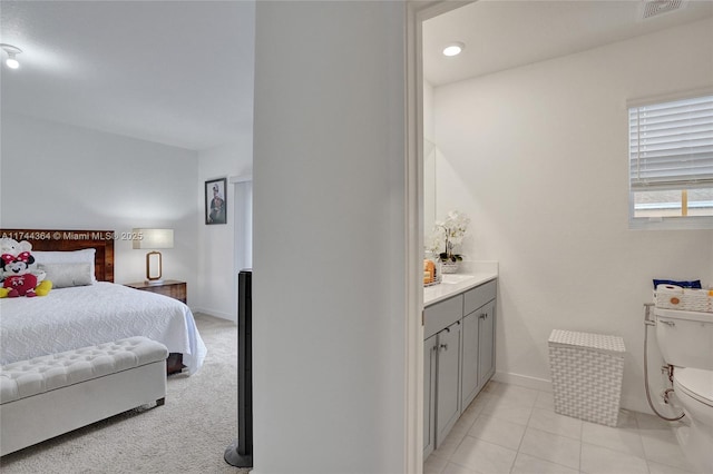 bedroom with light tile patterned floors, visible vents, and baseboards