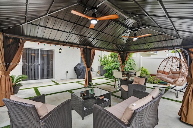 view of patio / terrace with ceiling fan, fence, a gazebo, an outdoor living space, and outdoor dining space