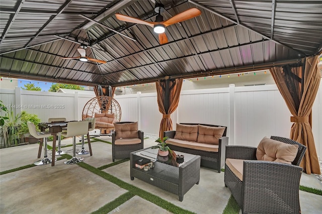 view of patio / terrace featuring a gazebo, outdoor lounge area, a fenced backyard, and a ceiling fan