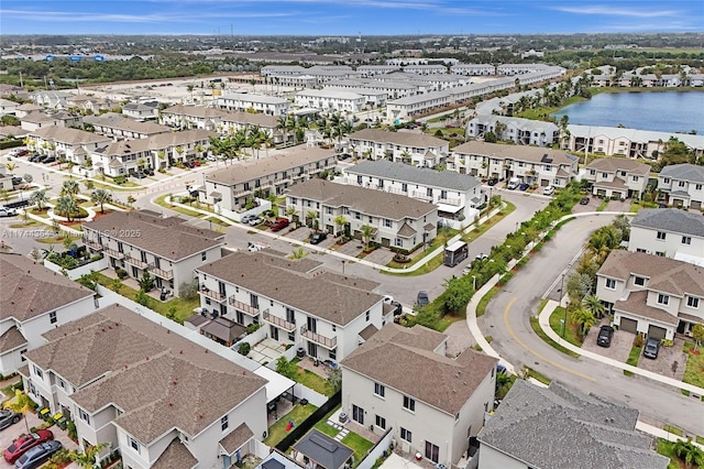 birds eye view of property with a water view and a residential view