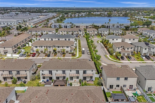 drone / aerial view with a residential view and a water view