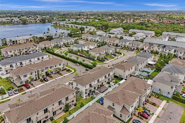 birds eye view of property with a water view and a residential view