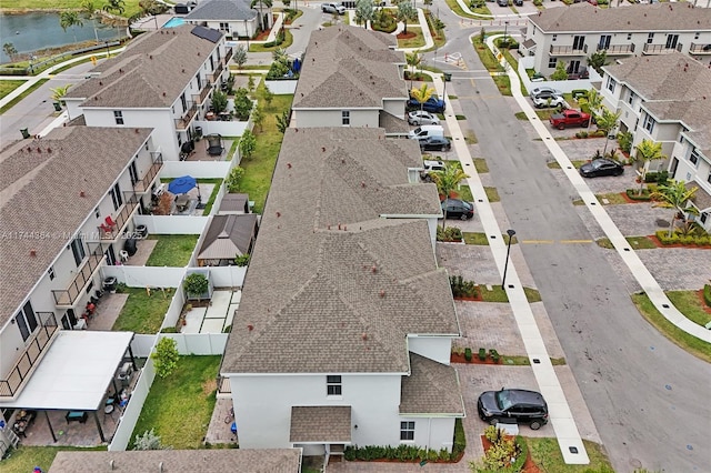 birds eye view of property with a water view and a residential view