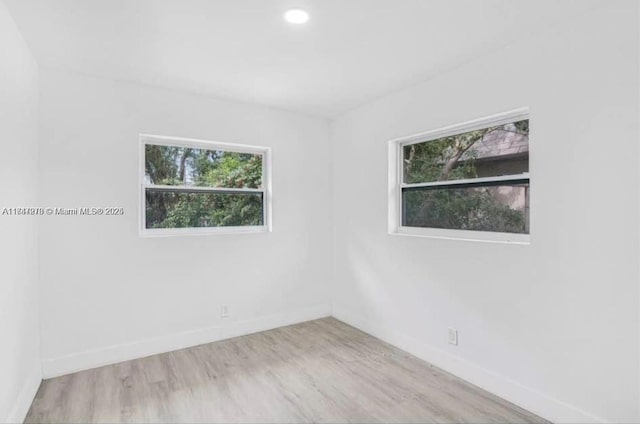 empty room with light hardwood / wood-style flooring