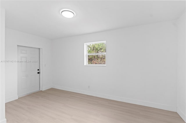 unfurnished room with light wood-type flooring