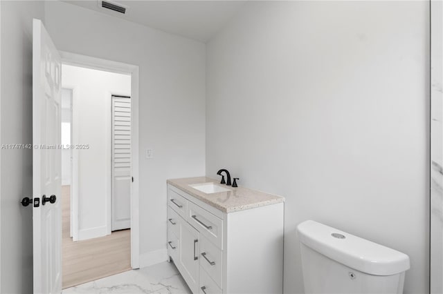 bathroom with toilet and vanity