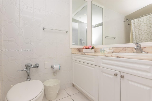 bathroom with tile walls, vanity, toilet, tile patterned floors, and a shower with shower curtain