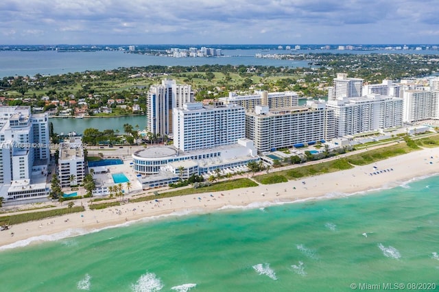 birds eye view of property featuring a water view and a view of the beach