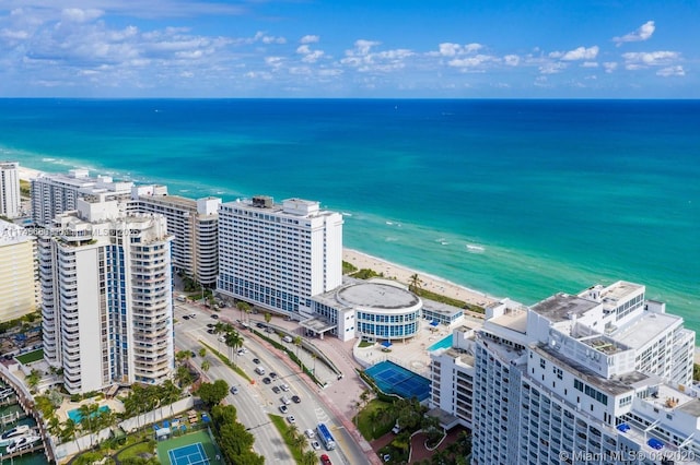 drone / aerial view featuring a water view and a beach view