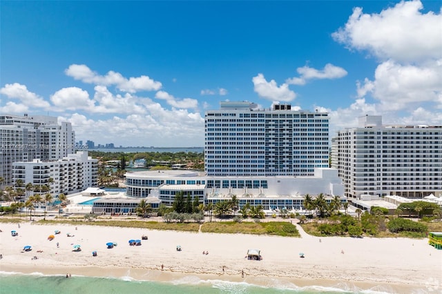 drone / aerial view featuring a water view and a beach view