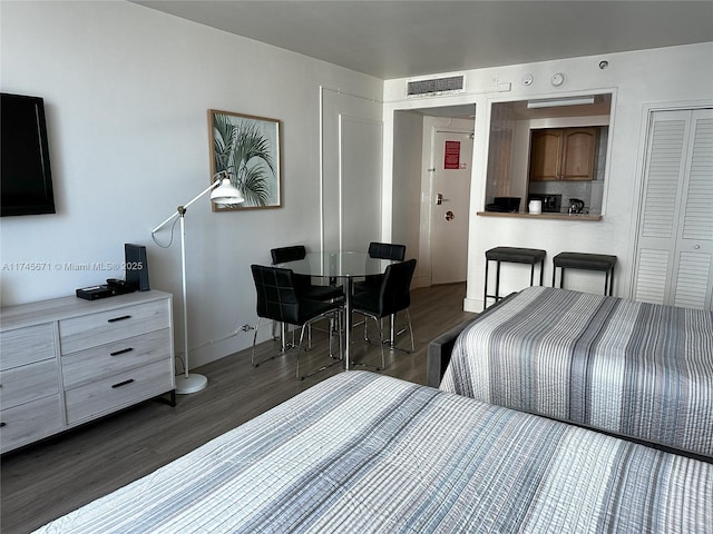 bedroom featuring a closet and dark hardwood / wood-style flooring