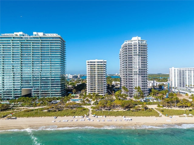 bird's eye view featuring a water view and a beach view