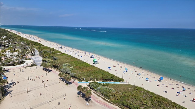 aerial view with a water view and a beach view