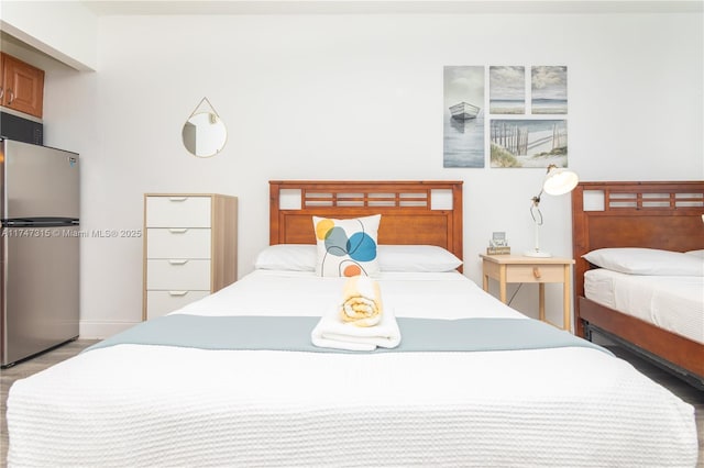 bedroom featuring stainless steel refrigerator