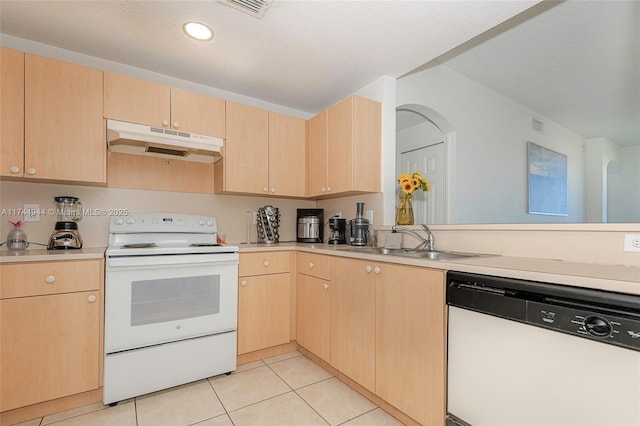 kitchen featuring kitchen peninsula, sink, white appliances, light tile patterned floors, and light brown cabinets