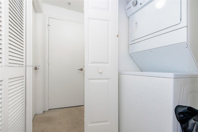 washroom with stacked washer / drying machine