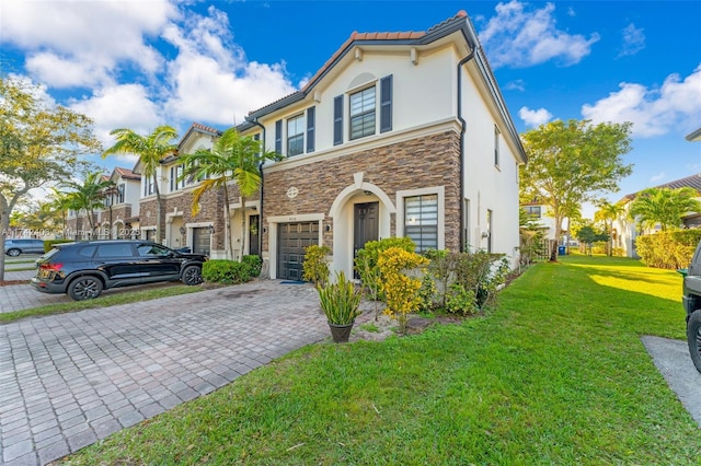 view of front facade featuring a front yard and a garage