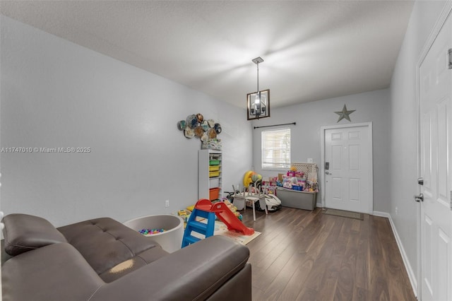 game room with dark wood-type flooring