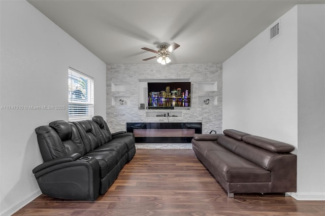 living room featuring ceiling fan and dark hardwood / wood-style flooring