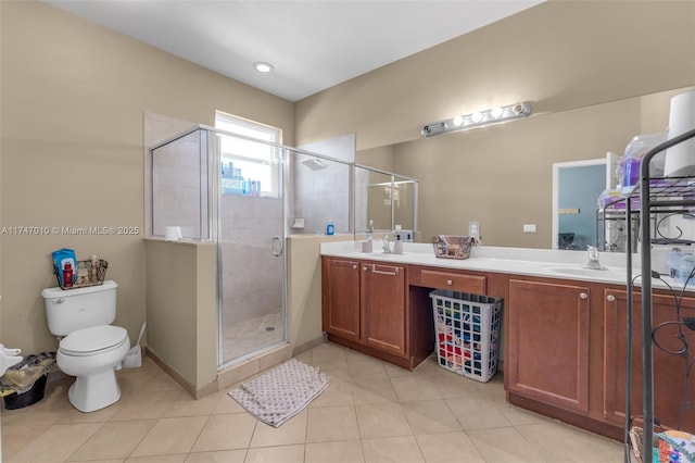 bathroom featuring an enclosed shower, vanity, toilet, and tile patterned floors