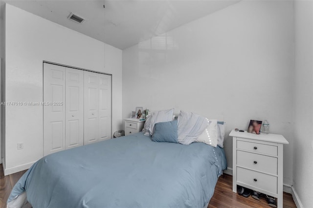 bedroom featuring a closet and dark hardwood / wood-style floors