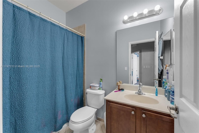 bathroom with vanity, toilet, and tile patterned flooring