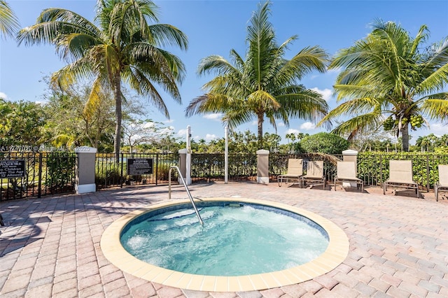 view of swimming pool featuring a patio and a community hot tub