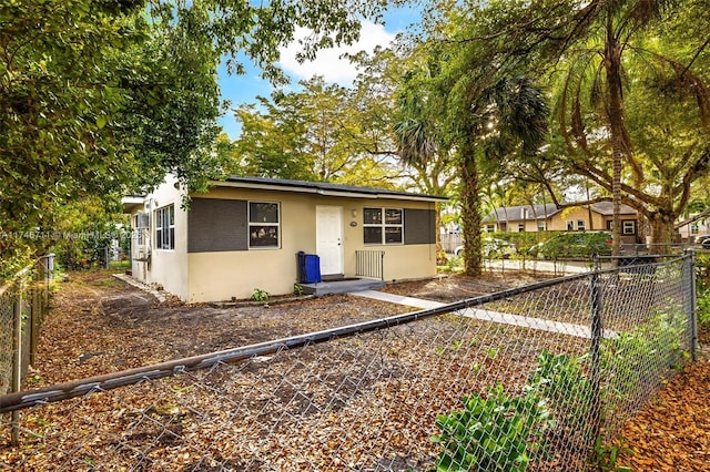 view of front of house with fence and stucco siding