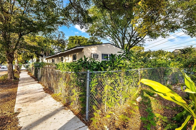 view of property exterior featuring fence and stucco siding