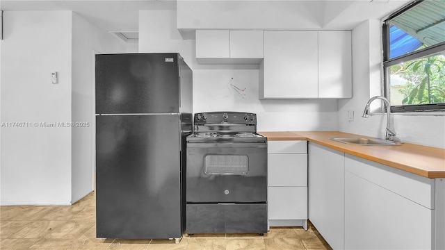 kitchen with black appliances, a sink, light countertops, and white cabinets