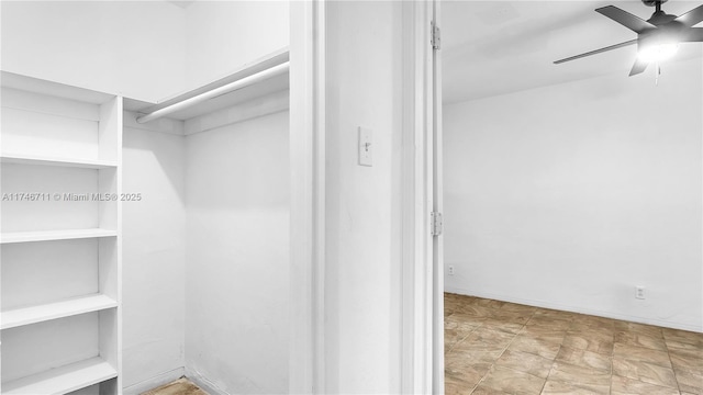 spacious closet with ceiling fan