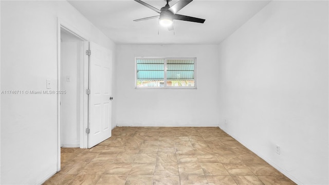 unfurnished room with a ceiling fan